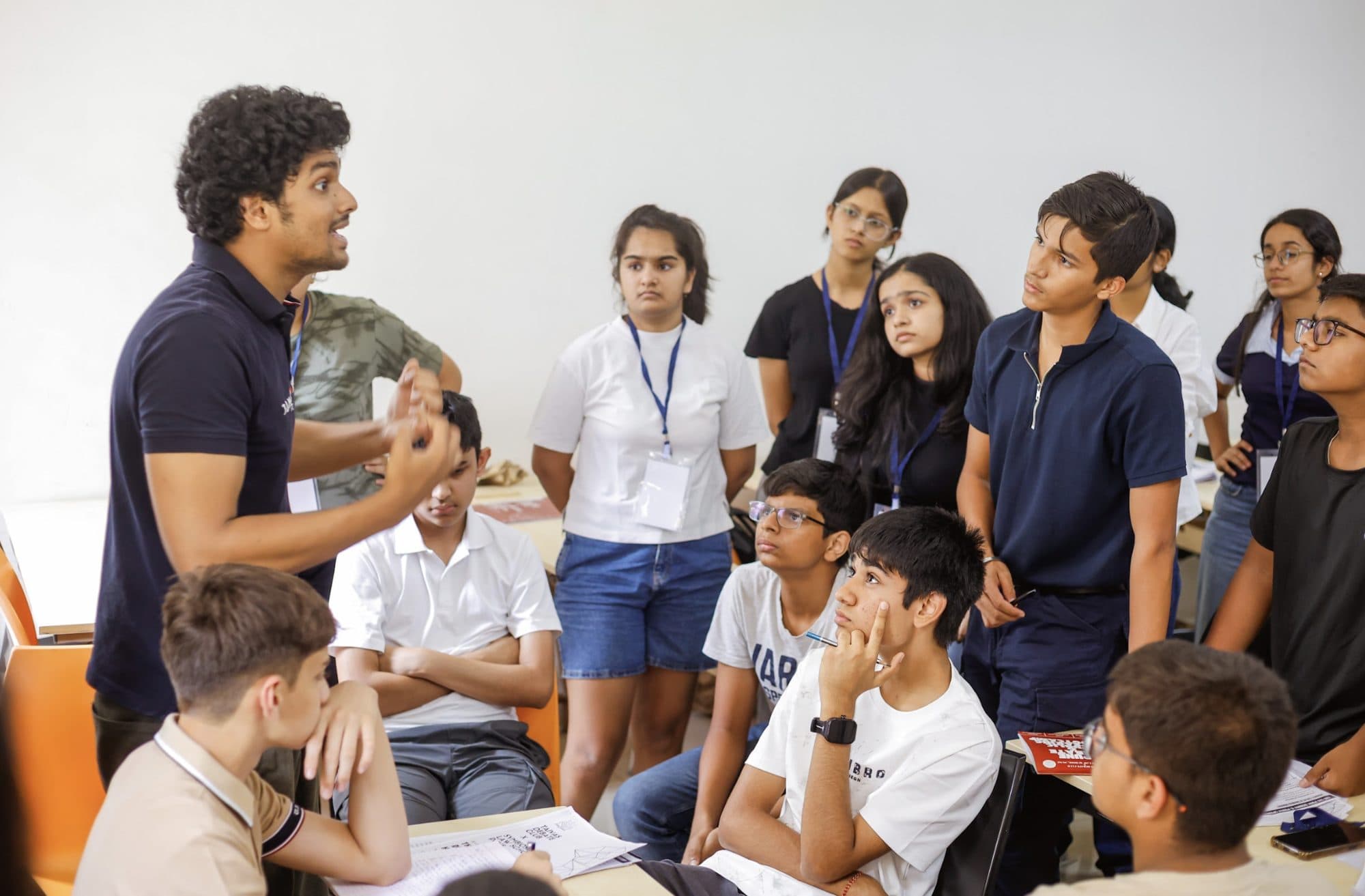 A Taivas coach teaching a standing group of senior students