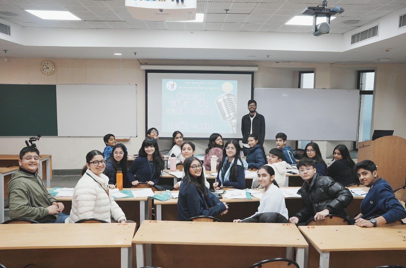 A Taivas batch with its coach in front of the screen