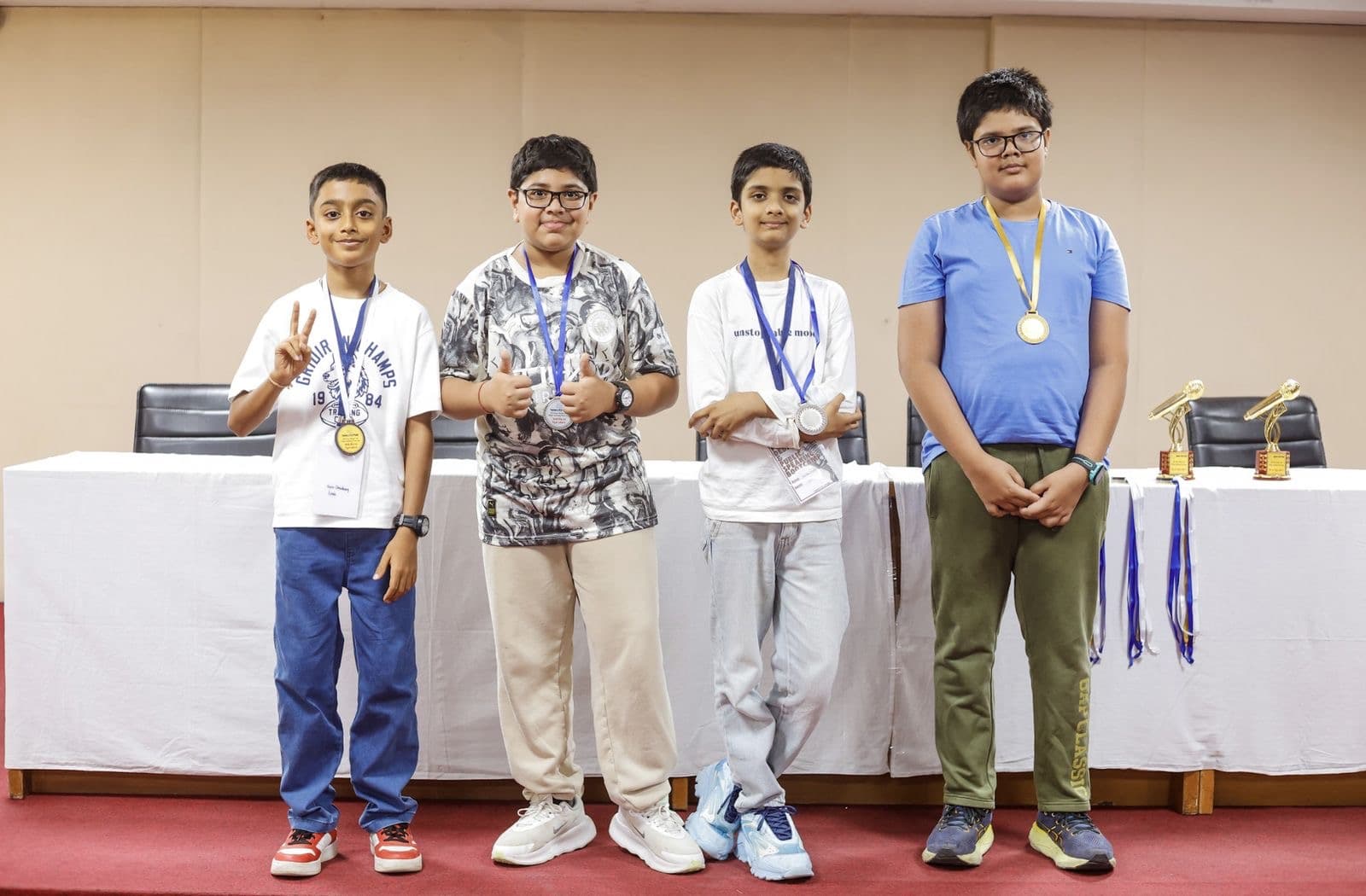 Four junior students with medals after a showcase