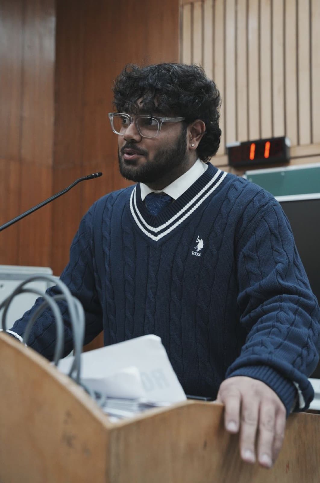 A boy speaking from a podium