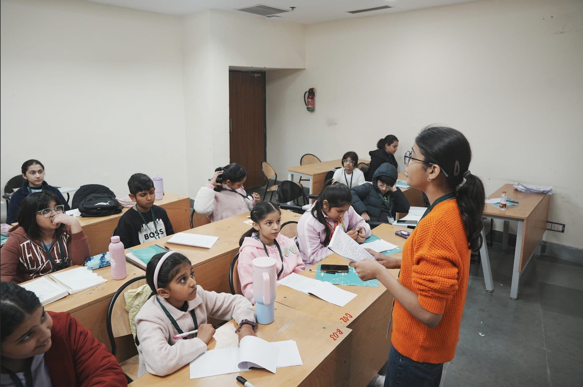 A Taivas coach reading with a batch of junior students