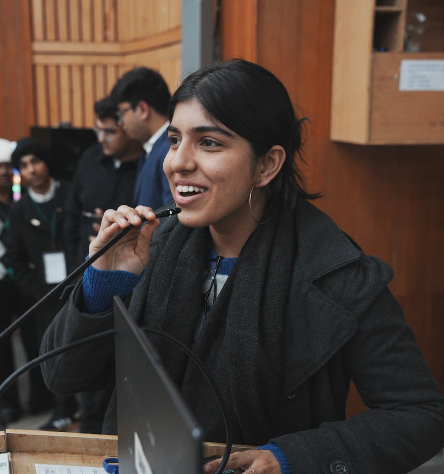 A student speaking at a microphone