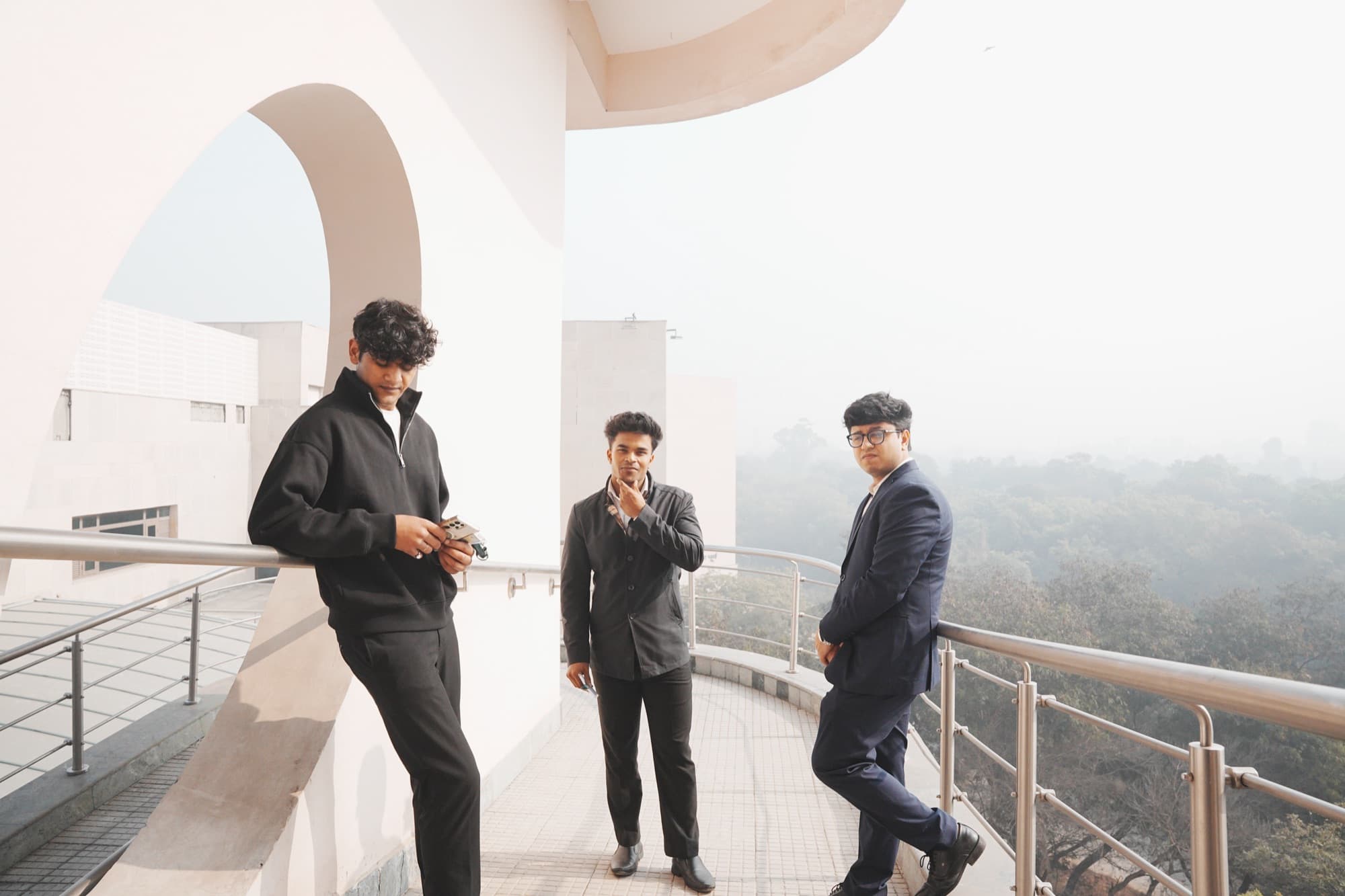 Three Taivas coaches on a balcony at IIT Delhi